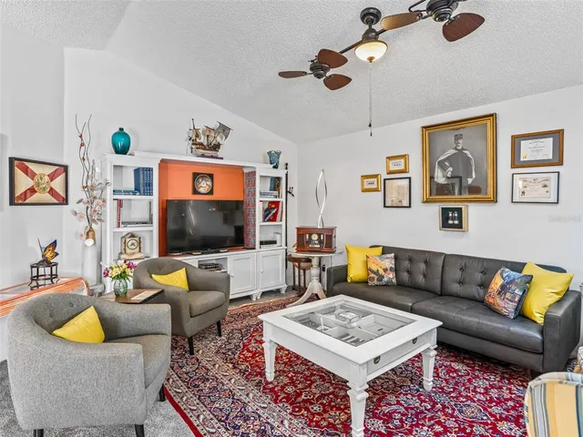 a living room with furniture a rug and a chandelier
