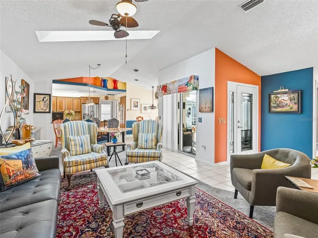 a kitchen with stainless steel appliances kitchen island granite countertop a table and chairs