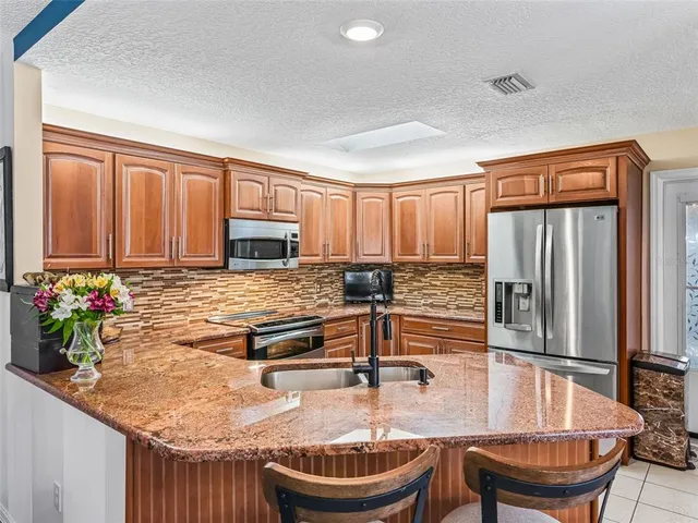 a view of a dining room with furniture and a chandelier