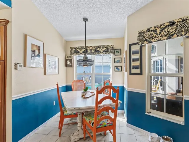 a bedroom with a large bed and a chandelier fan