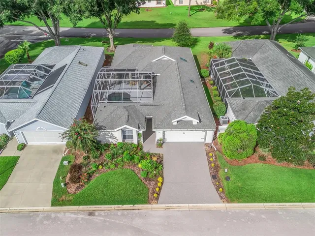an aerial view of a house with a yard