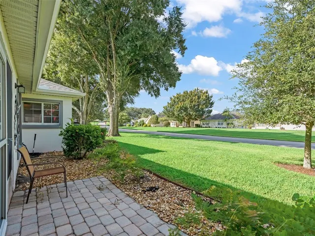 a swimming pool with outdoor seating and yard