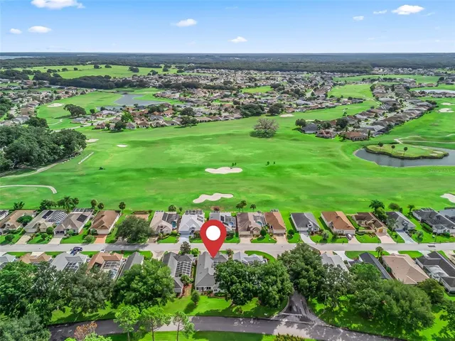 a view of a swimming pool with a bench and lawn chairs