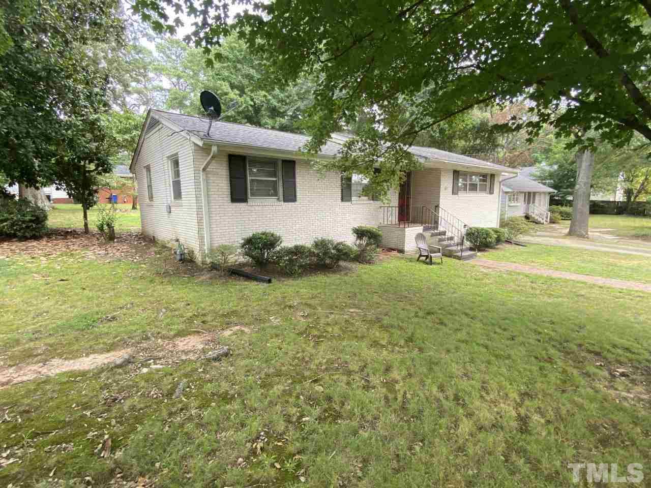 1412 Lyon Street Raleigh, NC 27608 - Photo 1 of 6 a view of a backyard with table and chairs and a large tree
