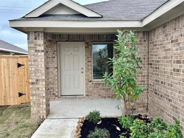 a front view of a house with plants