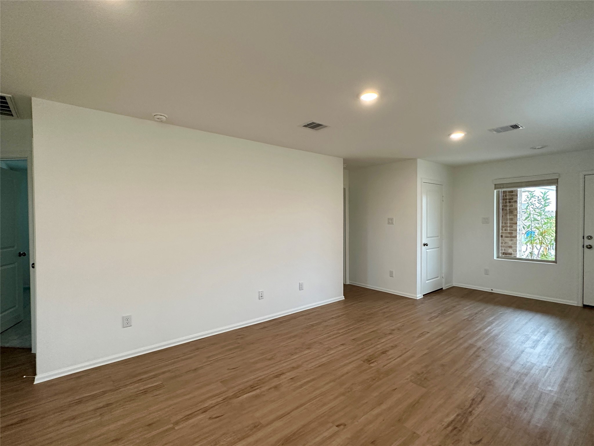 4130 Brazos Brook Trail Baytown, TX 77521 - Photo 3 of 20 an empty room with wooden floor and windows