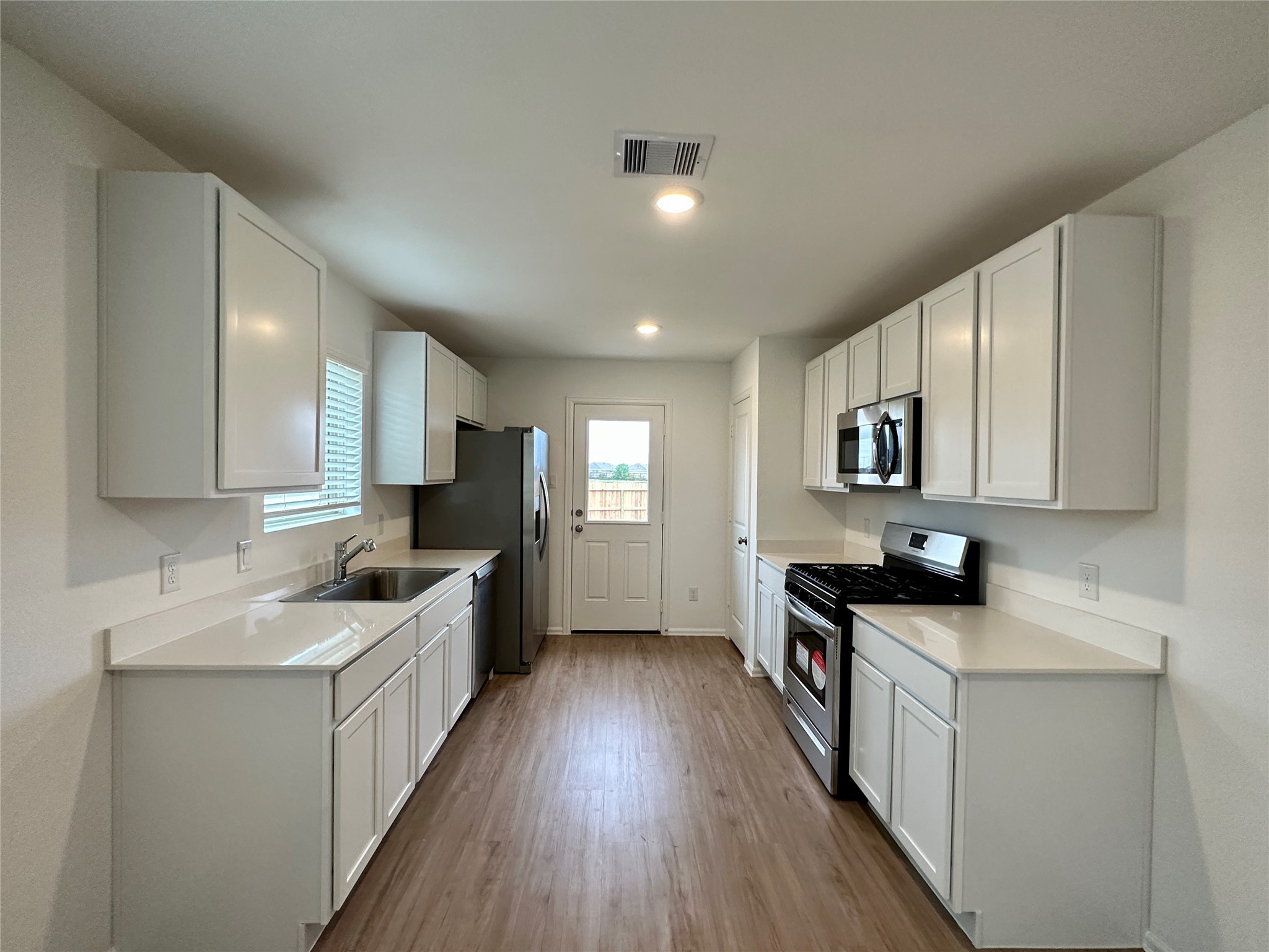 4130 Brazos Brook Trail Baytown, TX 77521 - Photo 5 of 20 a kitchen with granite countertop a sink a counter top space stainless steel appliances and cabinets