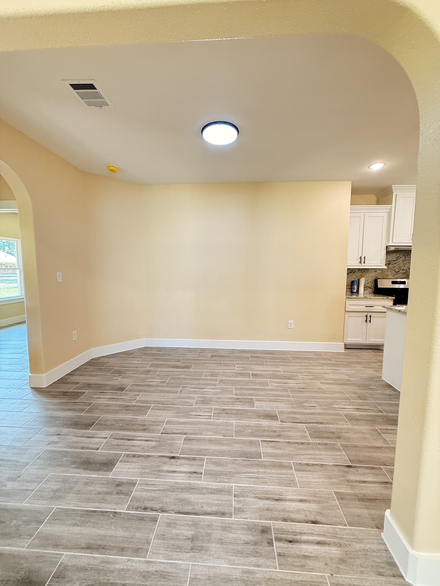 14844 Coaltown Road Willis, TX 77378 - Photo 12 of 30 a view of empty room with wooden floor and fan