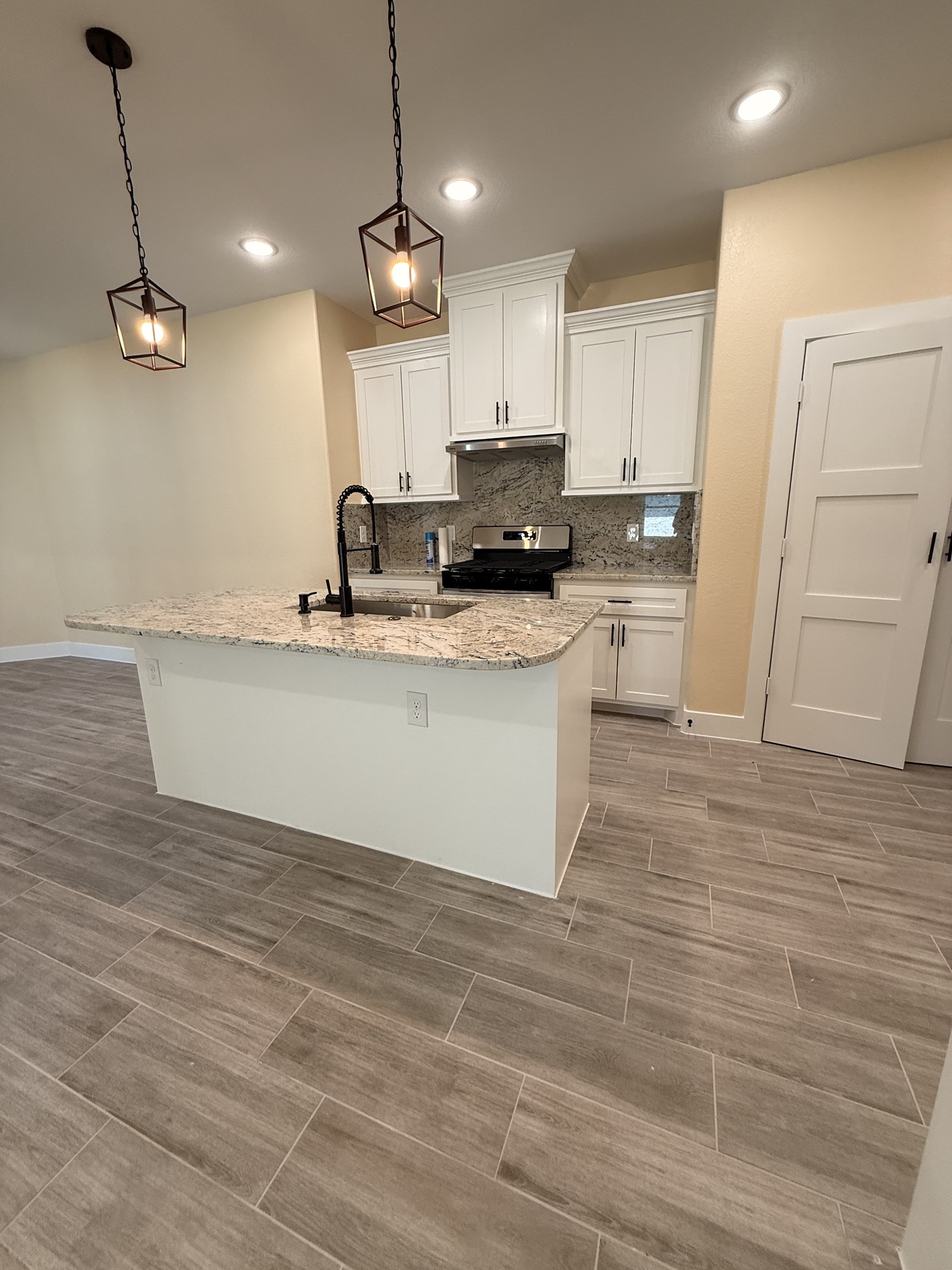 14844 Coaltown Road Willis, TX 77378 - Photo 14 of 30 a large kitchen with granite countertop a stove a sink a refrigerator and a granite counter top