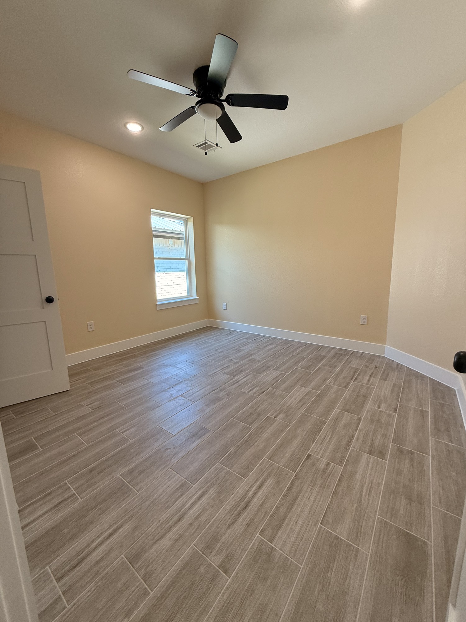 14844 Coaltown Road Willis, TX 77378 - Photo 25 of 30 an empty room with wooden floor and windows