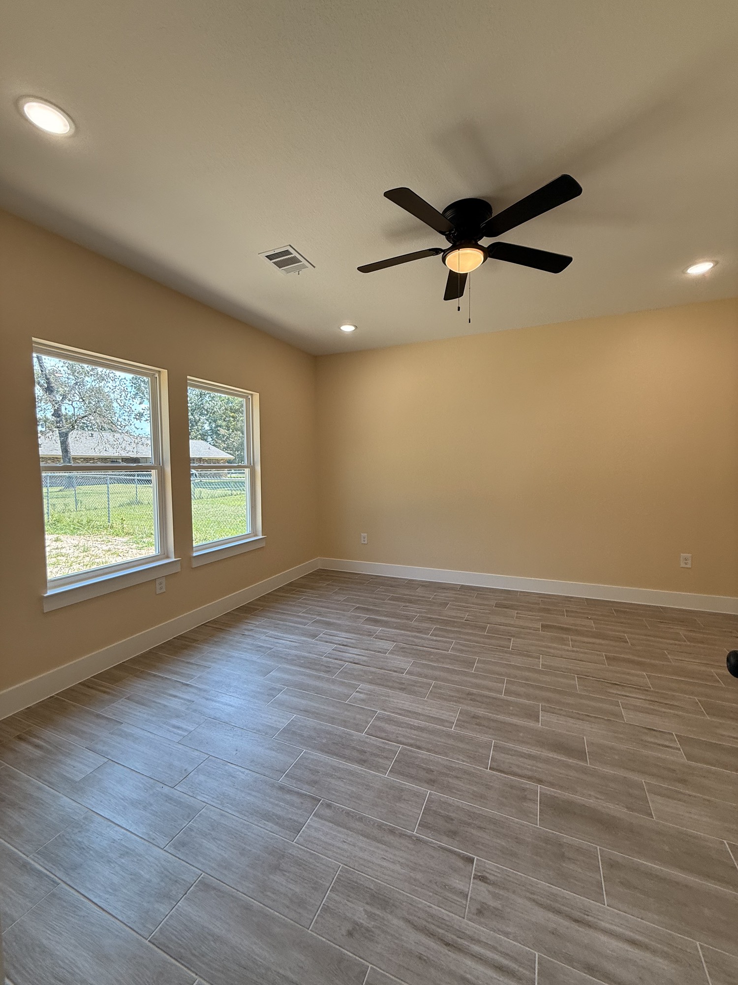 14844 Coaltown Road Willis, TX 77378 - Photo 4 of 30 wooden floor in an empty room with a window