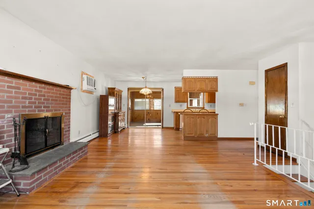a view of a living room with furniture and fireplace