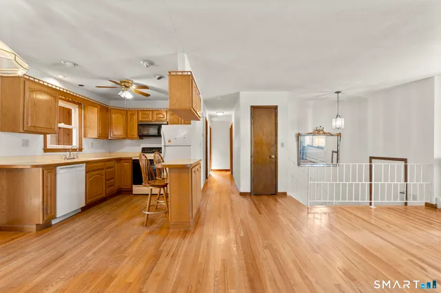a view of kitchen with cabinets and wooden floor