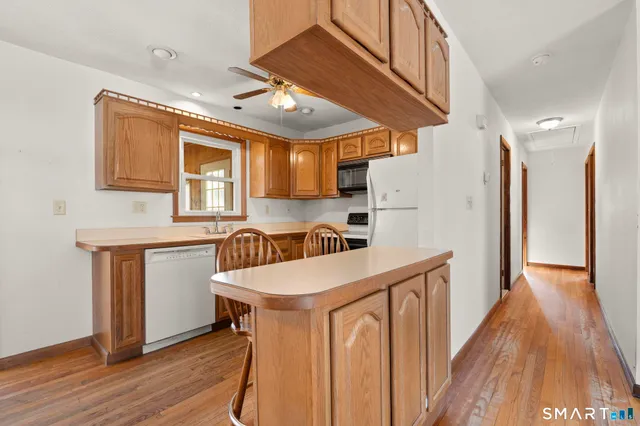 a kitchen with refrigerator cabinets and wooden floor