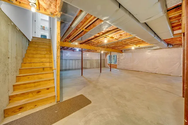 an empty room with a ceiling fan and window