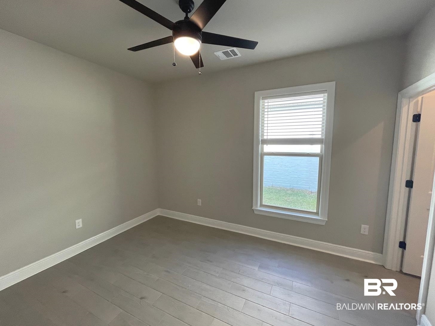 1634 Fenton Circle Foley, AL 36535 - Photo 5 of 14 Spare room featuring plenty of natural light, ceiling fan, and light hardwood / wood-style floors