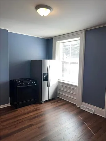 a kitchen with refrigerator and window