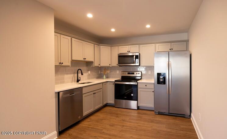 611 Main Street, Unit 201 Stroudsburg, PA 18360 - Photo 2 of 9 a kitchen with stainless steel appliances granite countertop a refrigerator and a sink
