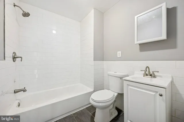 a bathroom with a sink toilet and bathtub