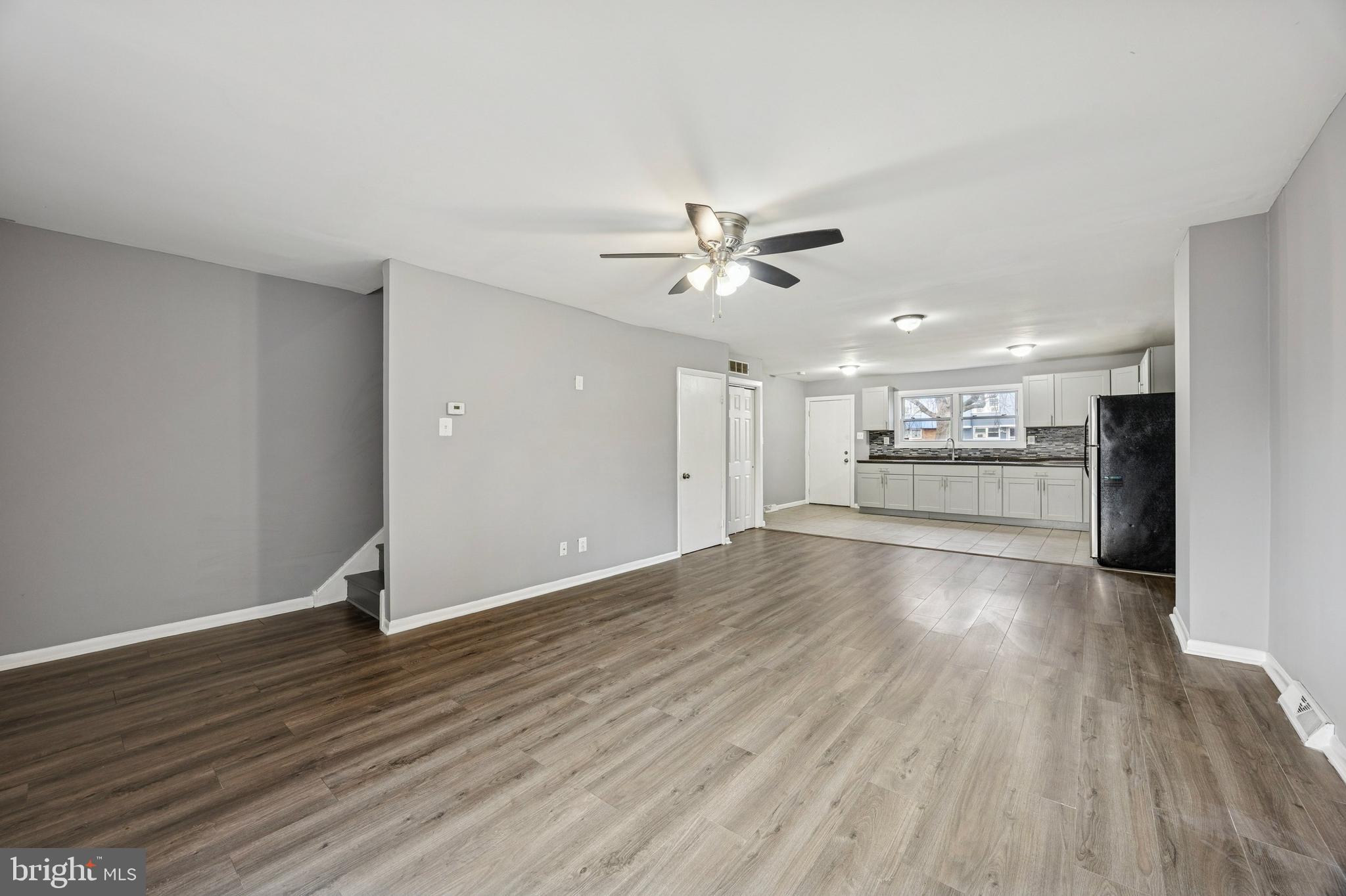 1340 West 7th Street Chester, PA 19013 - Photo 3 of 15 a view of an empty room with wooden floor and a kitchen
