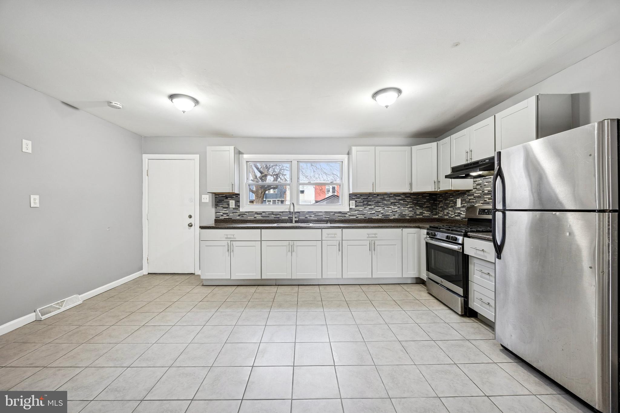 1340 West 7th Street Chester, PA 19013 - Photo 5 of 15 a kitchen with stainless steel appliances a refrigerator sink and cabinets