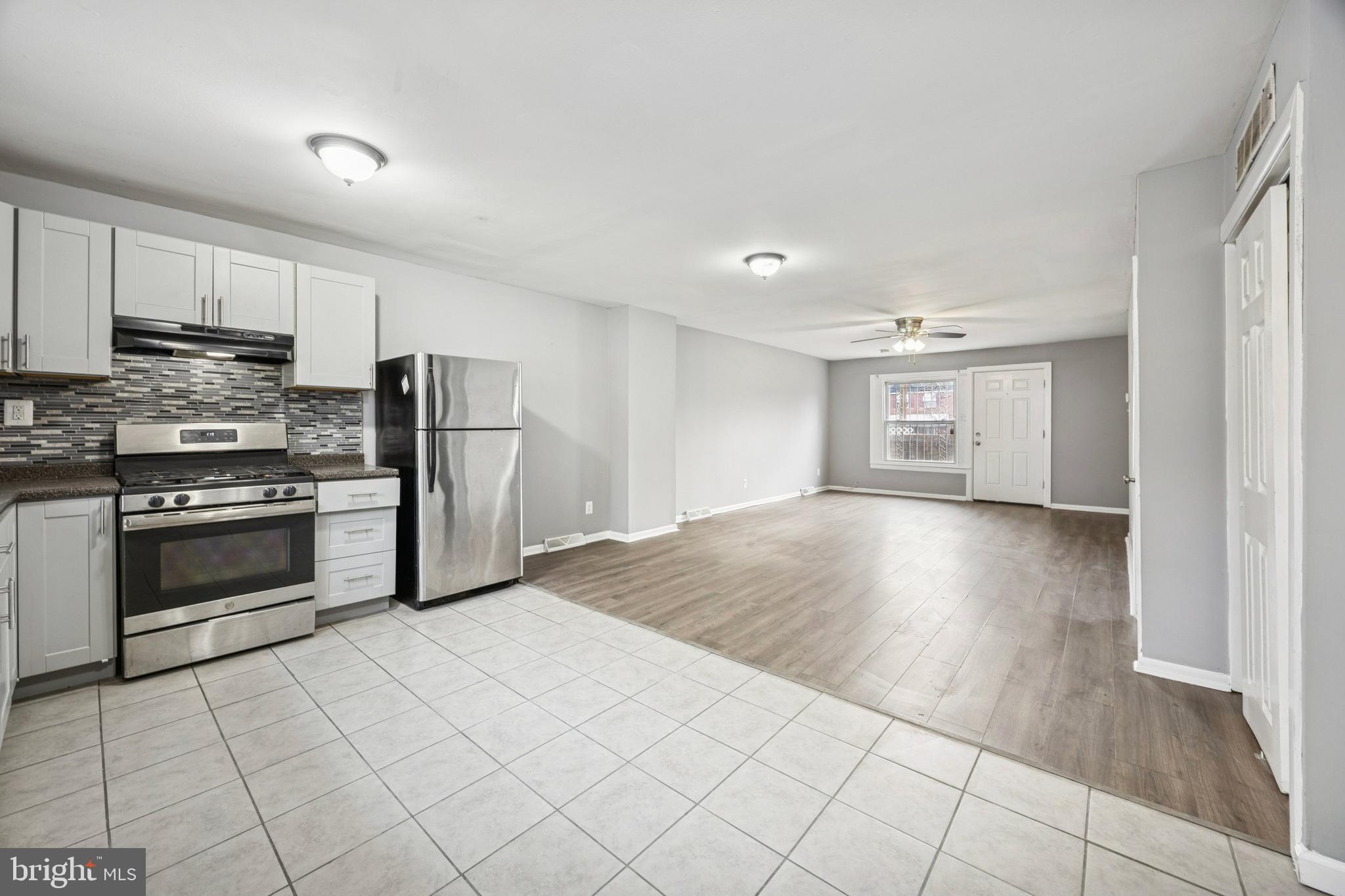 1340 West 7th Street Chester, PA 19013 - Photo 7 of 15 a kitchen with stainless steel appliances granite countertop a stove a sink and a refrigerator