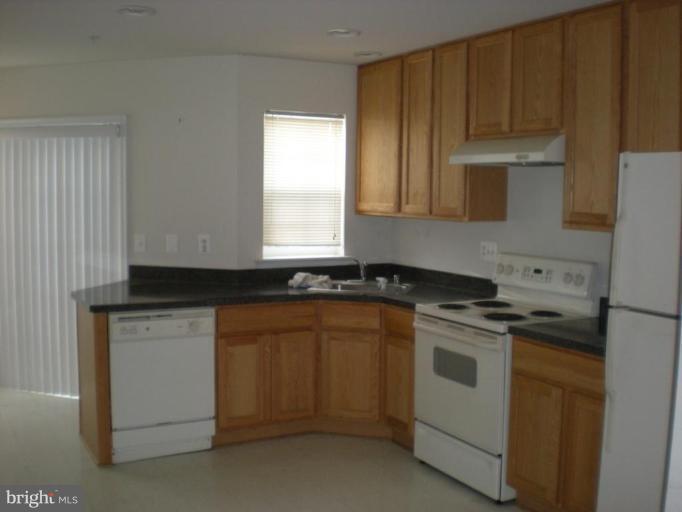 619 Tivoli Road Frederick, MD 21703 - Photo 2 of 5 a kitchen with granite countertop cabinets stainless steel appliances and a sink