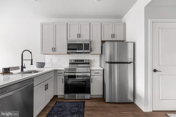 a kitchen with a white cabinets and stainless steel appliances