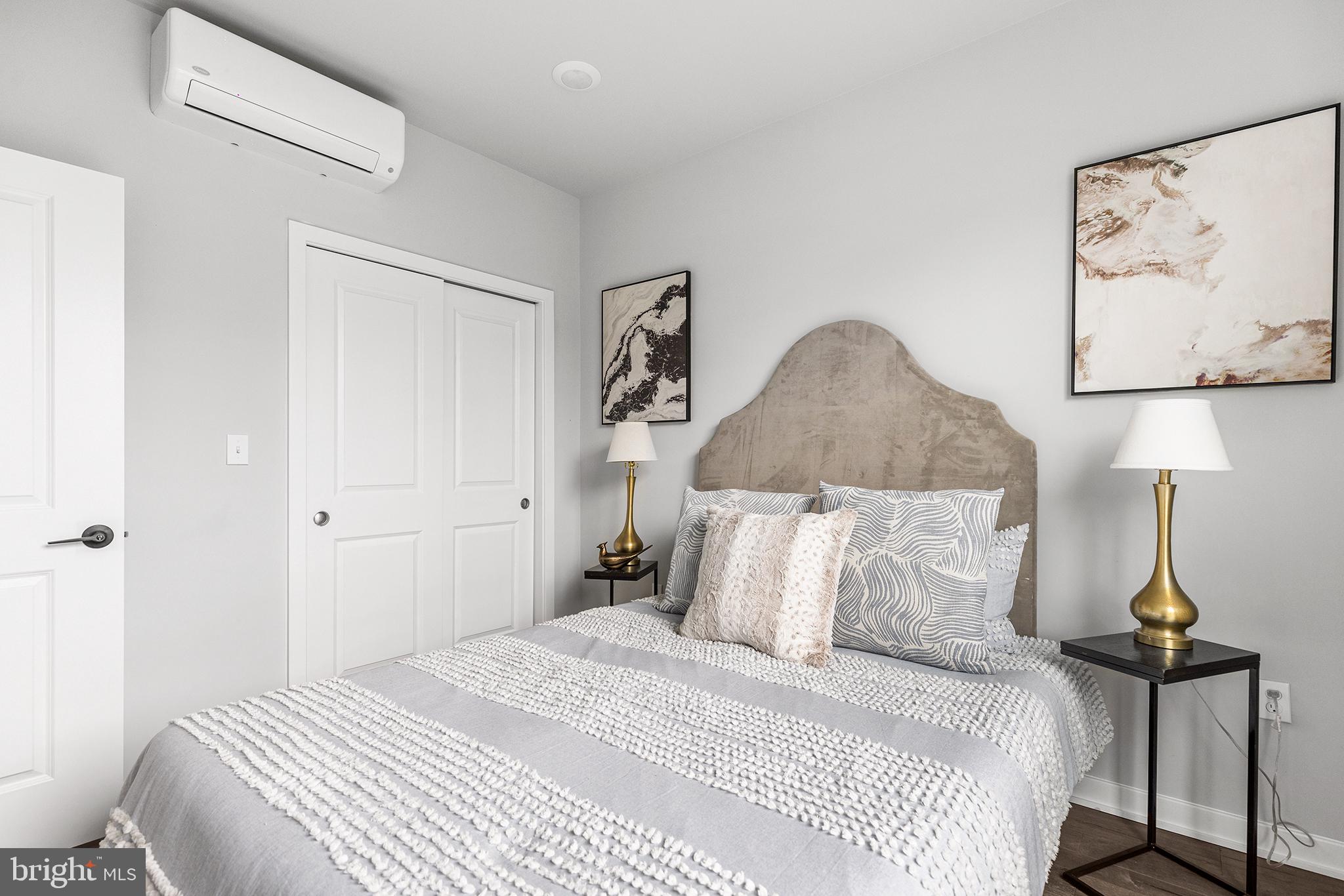 5542-44 Ridge Avenue, Unit 321 Philadelphia, PA 19128 - Photo 9 of 16 a bedroom with a bed and a painting on the wall