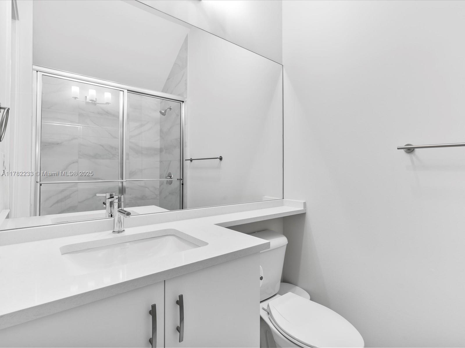 20324 Castle Stuart Avenue Boca Raton, FL 33434 - Photo 11 of 79 a bathroom with a sink a toilet and shower