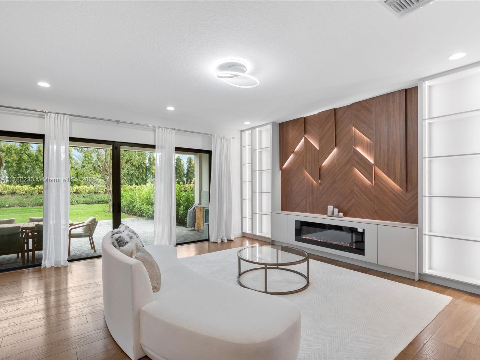 20324 Castle Stuart Avenue Boca Raton, FL 33434 - Photo 13 of 79 a living room with furniture a flat screen tv and a large window