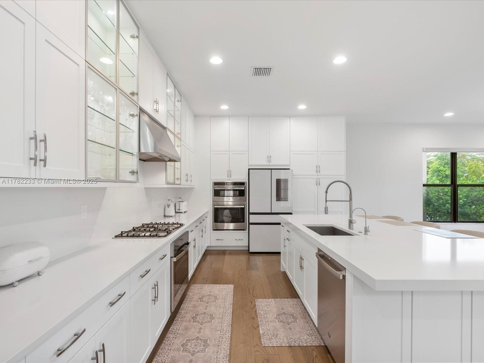 20324 Castle Stuart Avenue Boca Raton, FL 33434 - Photo 18 of 79 a large kitchen with stainless steel appliances a sink a counter top space and cabinets