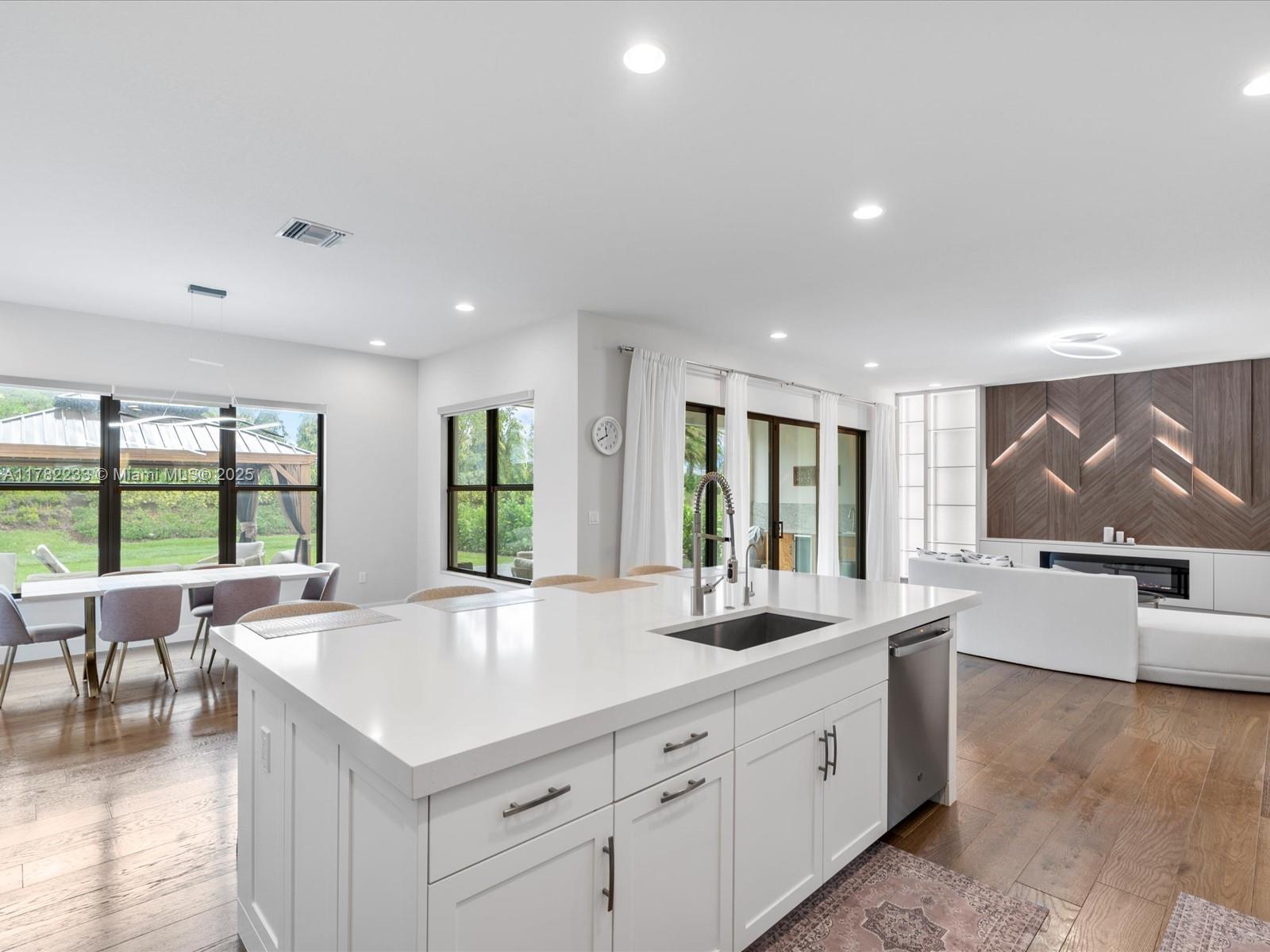 20324 Castle Stuart Avenue Boca Raton, FL 33434 - Photo 21 of 79 a large white kitchen with a large window