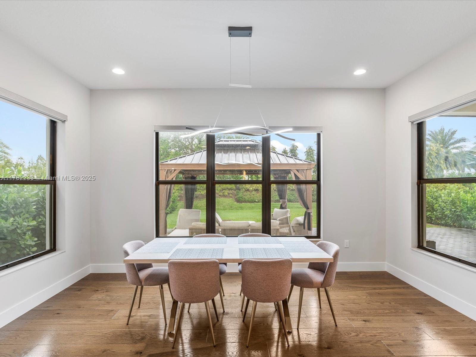 20324 Castle Stuart Avenue Boca Raton, FL 33434 - Photo 26 of 79 a dining room with a table and chairs