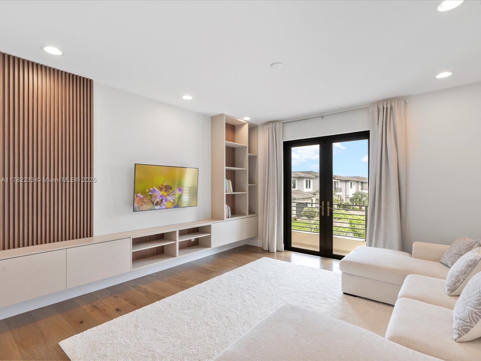 20324 Castle Stuart Avenue Boca Raton, FL 33434 - Photo 31 of 79 a living room with furniture and a flat screen tv