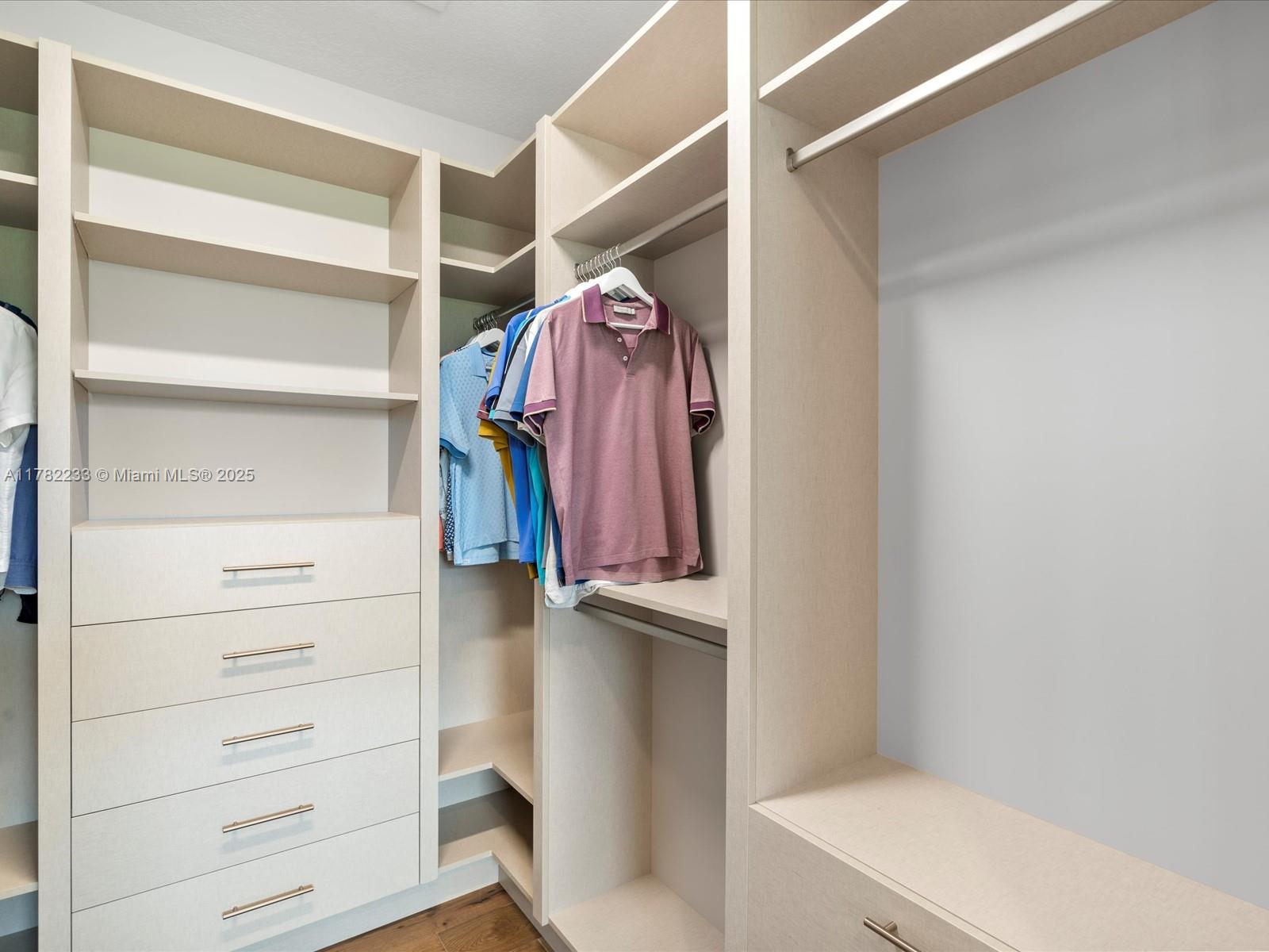 20324 Castle Stuart Avenue Boca Raton, FL 33434 - Photo 37 of 79 a view of walk in closet with empty racks