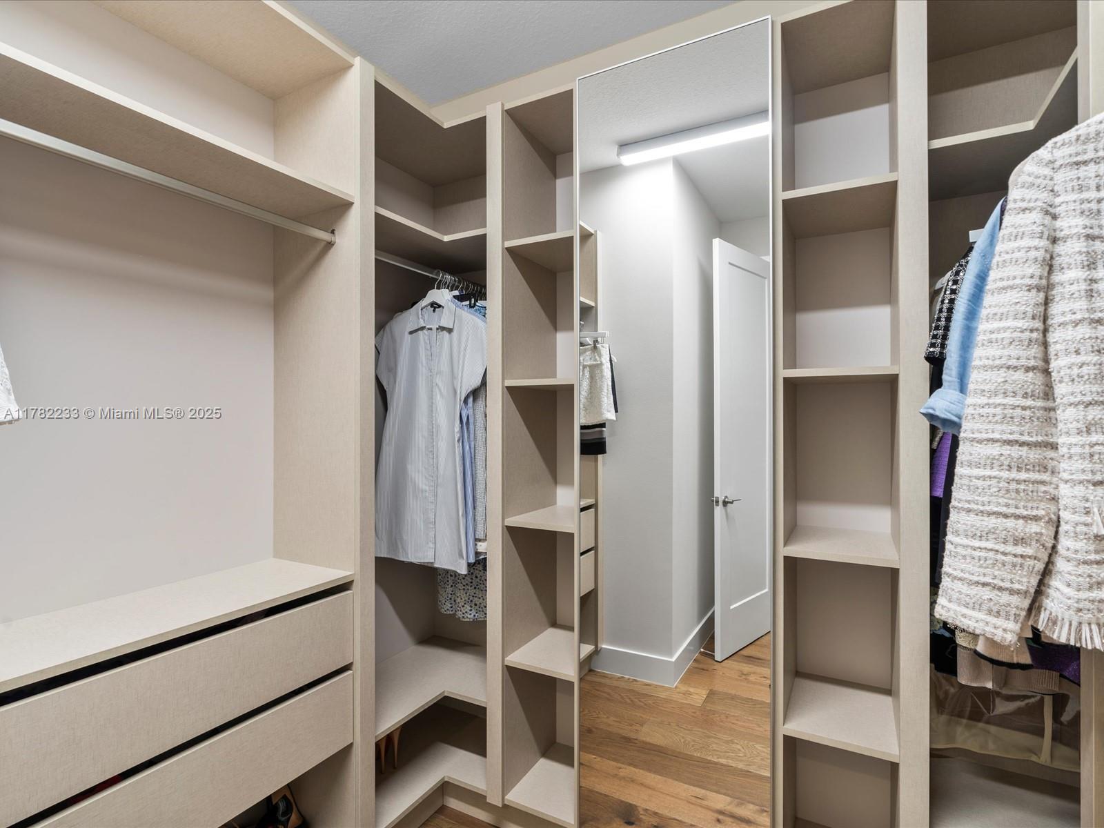 20324 Castle Stuart Avenue Boca Raton, FL 33434 - Photo 39 of 79 a view of walk in closet with clothes and shoes