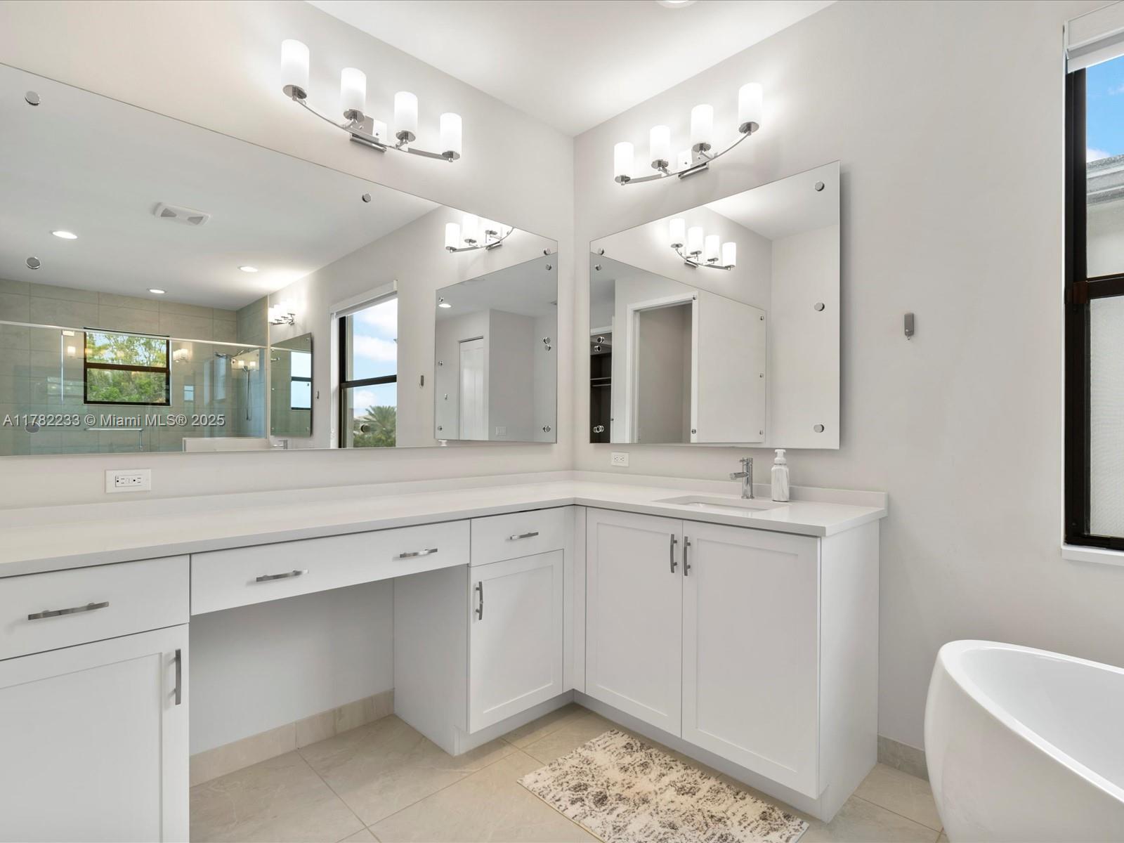 20324 Castle Stuart Avenue Boca Raton, FL 33434 - Photo 42 of 79 a bathroom with a sink vanity and a mirror