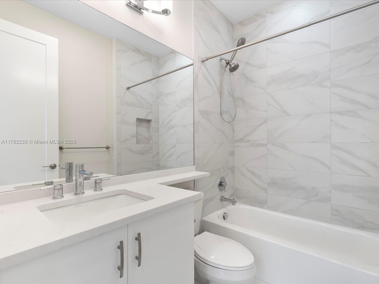 20324 Castle Stuart Avenue Boca Raton, FL 33434 - Photo 45 of 79 a bathroom with a sink a toilet and a bathtub