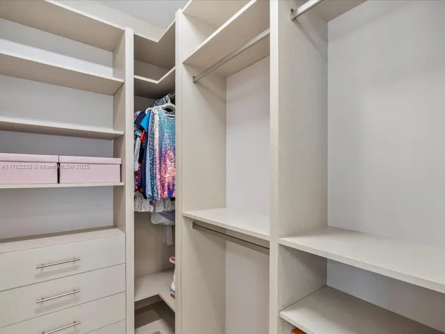 a view of a swimming pool with lounge chairs in patio