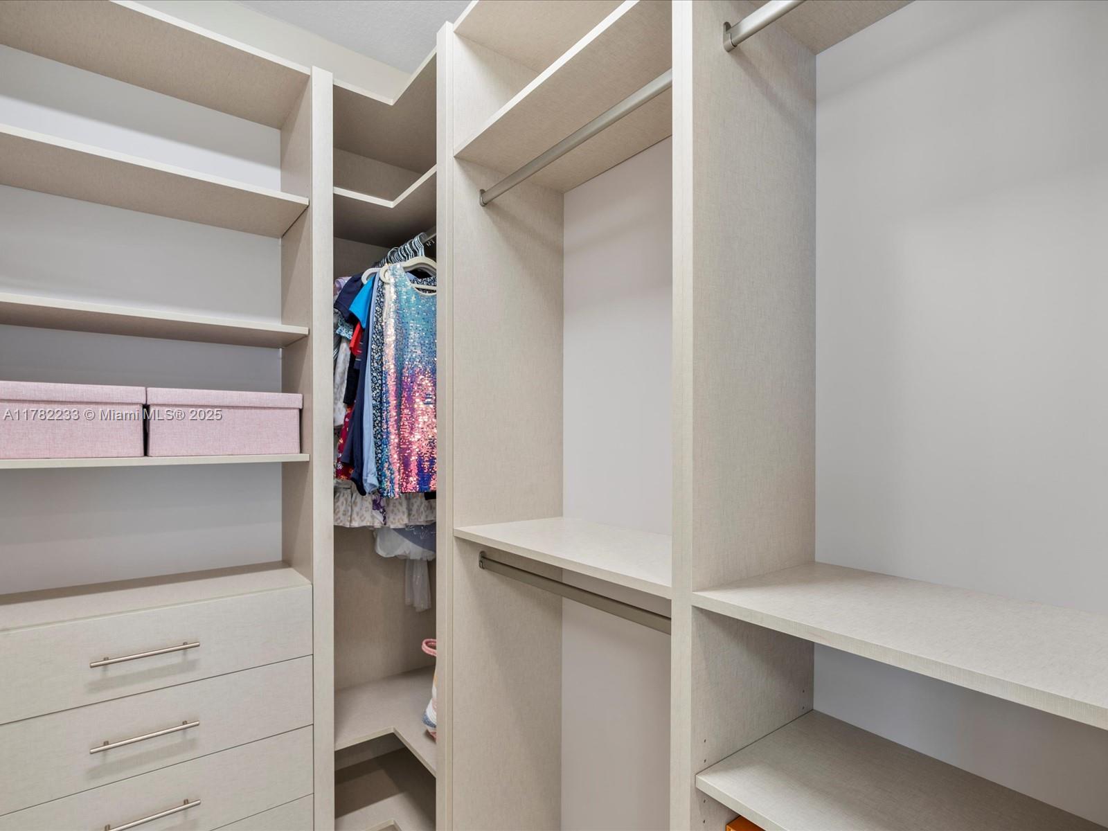 20324 Castle Stuart Avenue Boca Raton, FL 33434 - Photo 46 of 79 a view of walk in closet with clothes