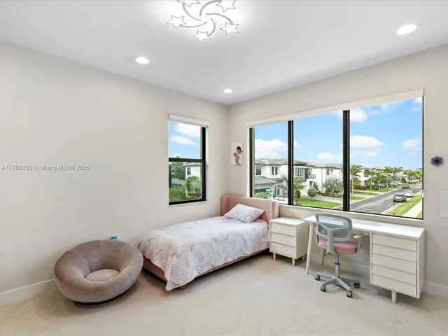 a view of swimming pool with a lounge chairs and a small yard