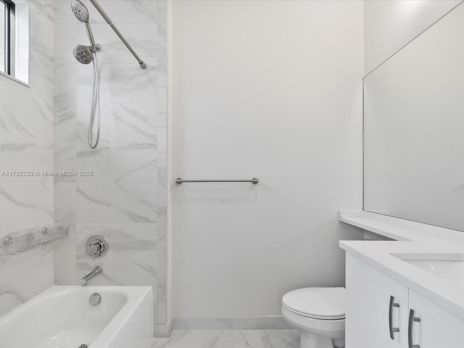 20324 Castle Stuart Avenue Boca Raton, FL 33434 - Photo 50 of 79 a bathroom with a sink a toilet and a bathtub