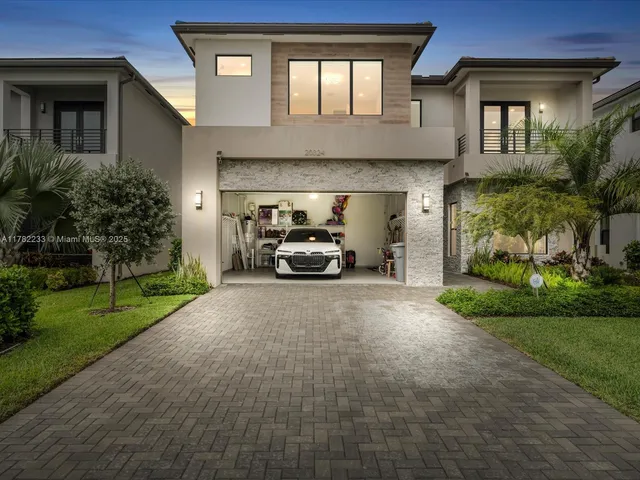 a car parked in front of a brick house