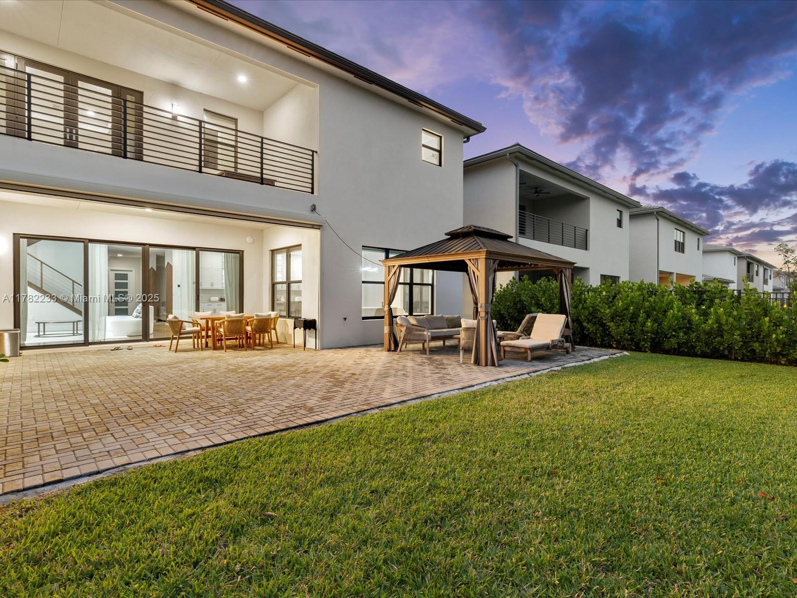 20324 Castle Stuart Avenue Boca Raton, FL 33434 - Photo 58 of 79 a patio with a table and chairs and potted plants