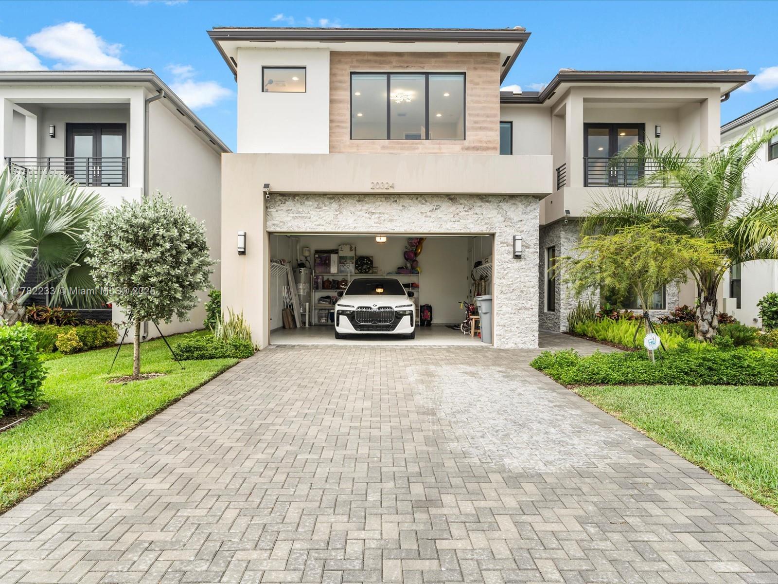 20324 Castle Stuart Avenue Boca Raton, FL 33434 - Photo 6 of 79 a car parked in front of a brick house