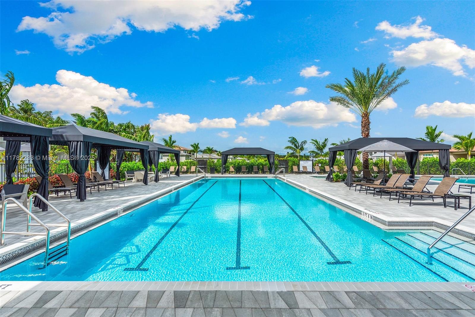 20324 Castle Stuart Avenue Boca Raton, FL 33434 - Photo 70 of 79 a view of a swimming pool with lounge chairs in patio