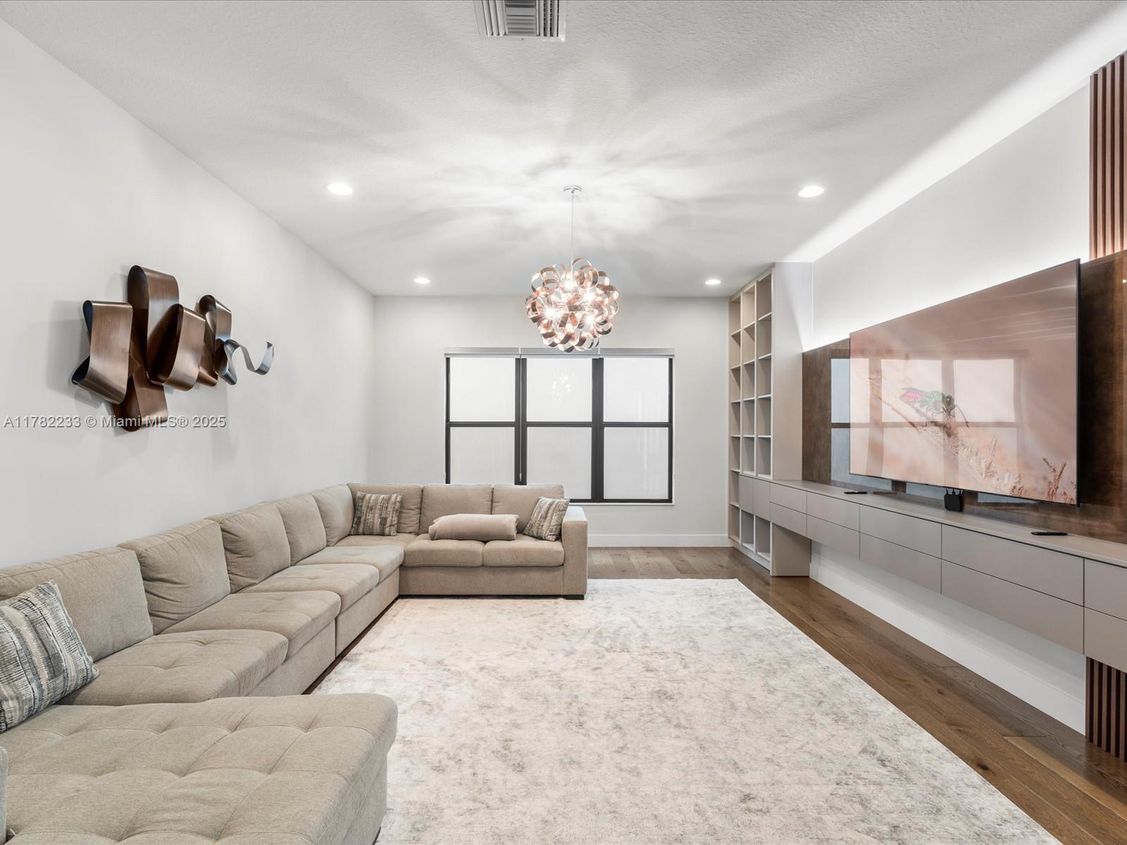 20324 Castle Stuart Avenue Boca Raton, FL 33434 - Photo 7 of 79 a living room with furniture and a large window