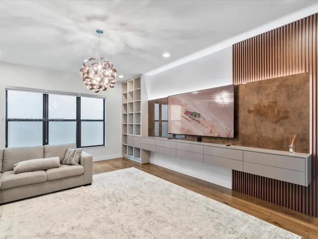 a living room with furniture and a chandelier