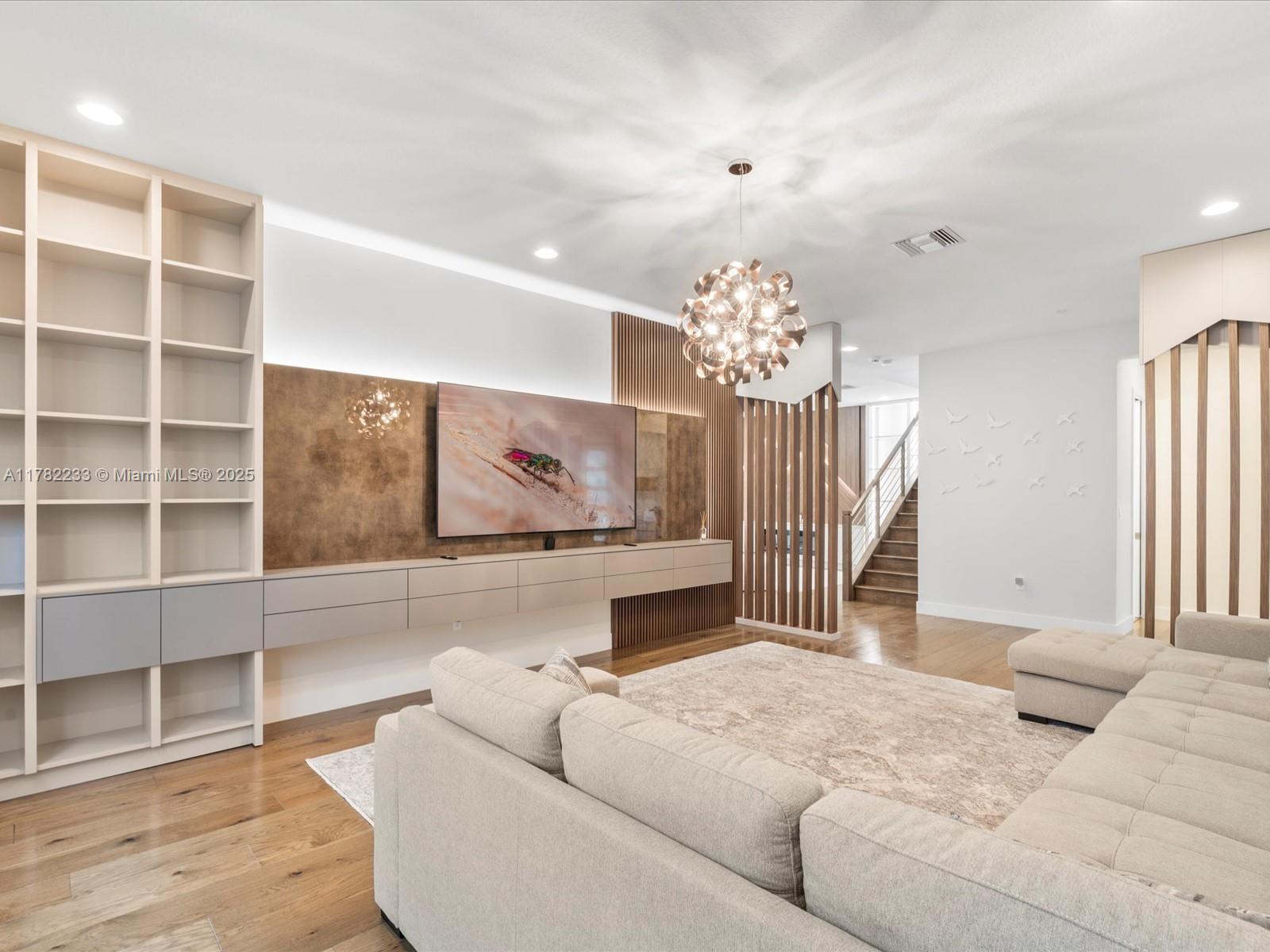 20324 Castle Stuart Avenue Boca Raton, FL 33434 - Photo 9 of 79 a living room with furniture and a chandelier